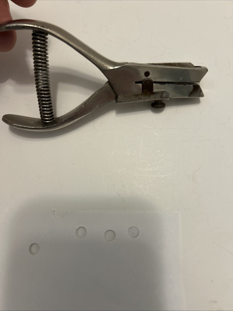 Vintage hole punch with spring handle action and adjustable punch depth guide