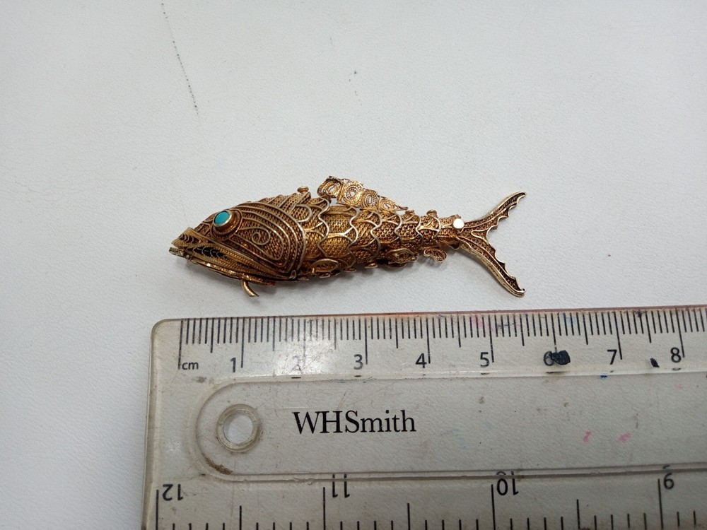 Tested as silver and gilded flexible fish, possibly pill box.