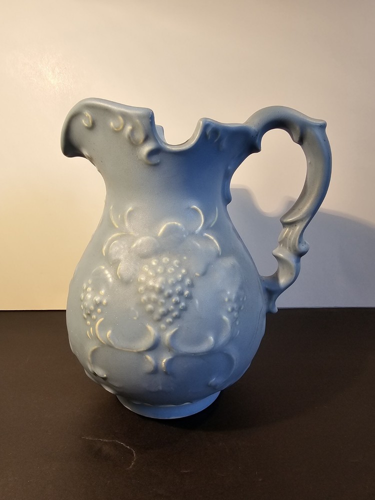 Blue Pitcher With Grapes And Leaves On The Side
