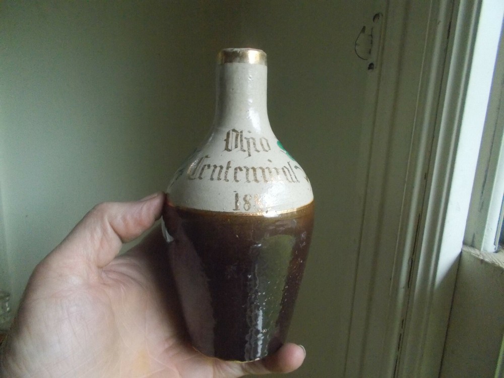 1888 DATED OHIO CENTENNIAL STONEWARE BOTTLE HAND PAINTED FLOWERS HANDLE BROKEN