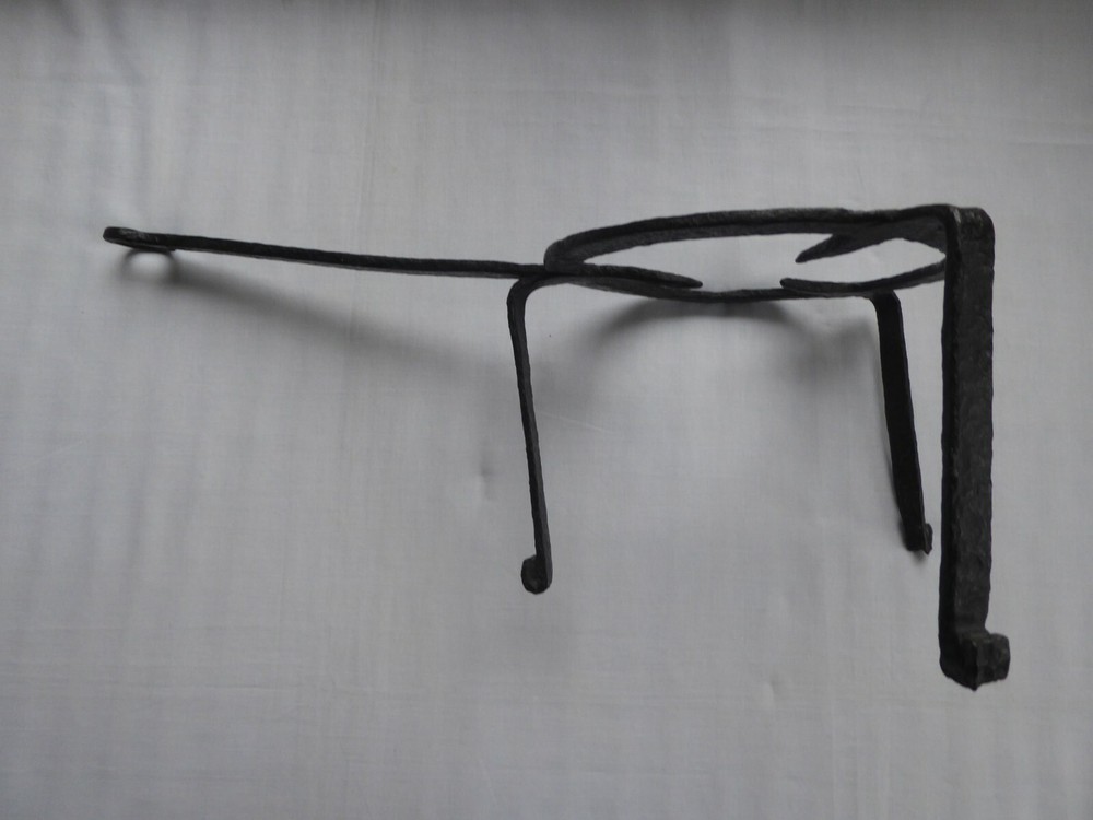 A 18TH CENTURY PRMATIVE FORGED IRON TRIVET