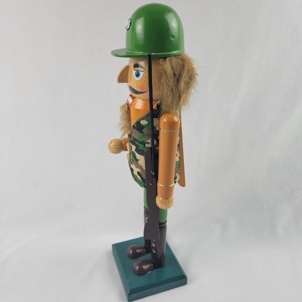 Wooden camouflage nutcracker with a rifle