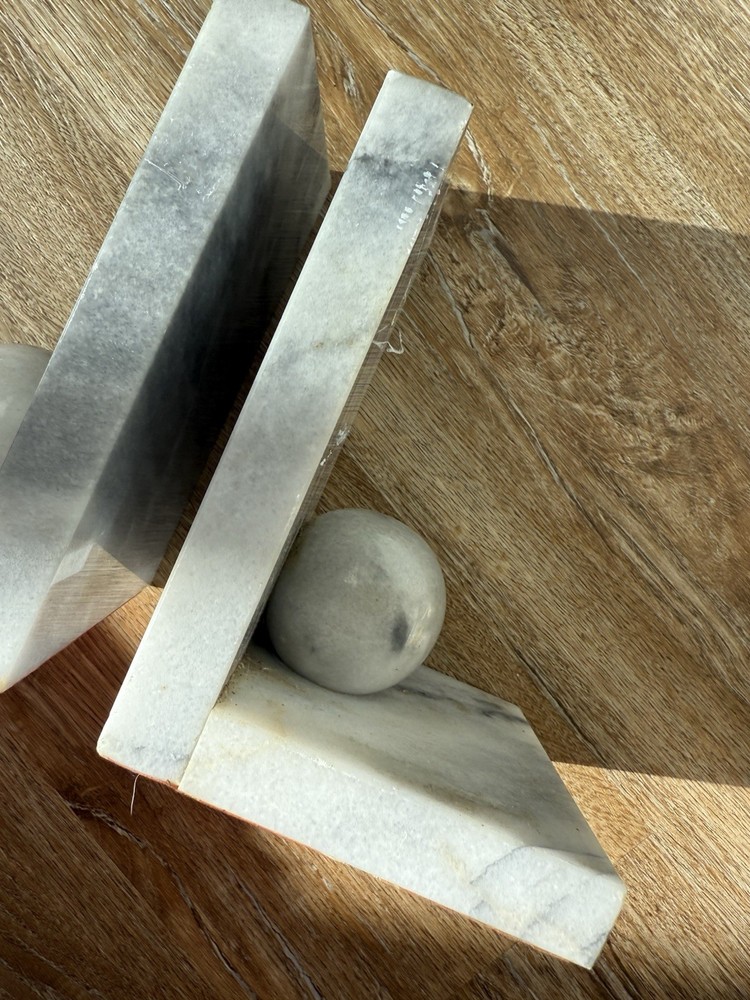Vintage marble bookends with spherical elements.