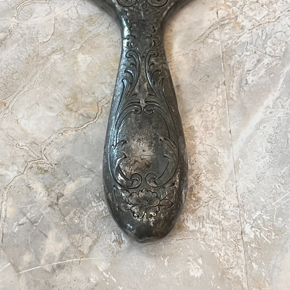 Silver Plated Hand Held Mirror with Intricate Raised Floral Scrollwork