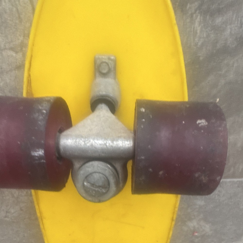 Silver Skateboard Trucks Red Wheels Mounted on Yellow Deck