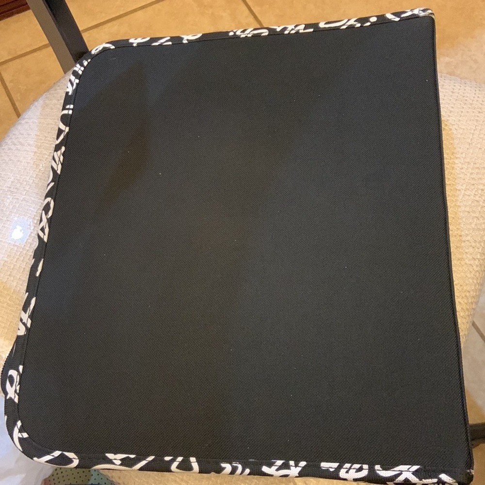 Justice brand binder with LOVE black dots.