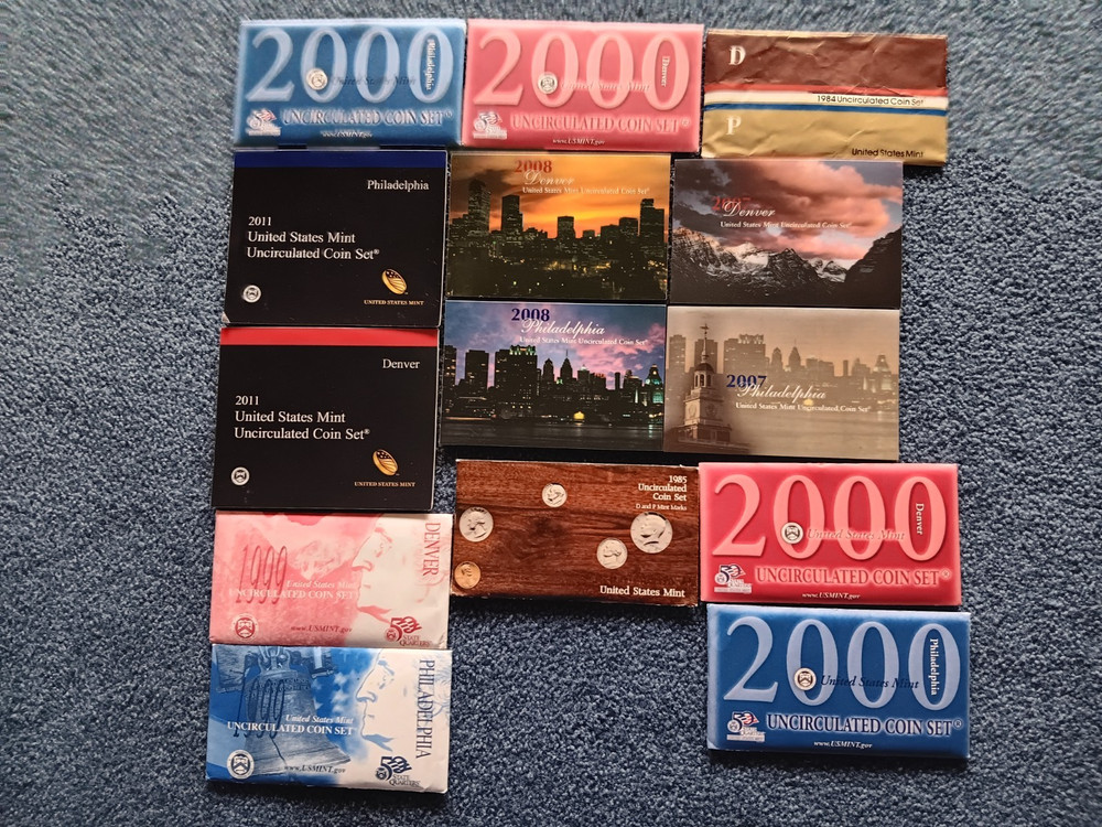 $221. FACE MINT SETS STILL IN ENVELOPES AND SOFT PLASTIC AS FROM THE MINT