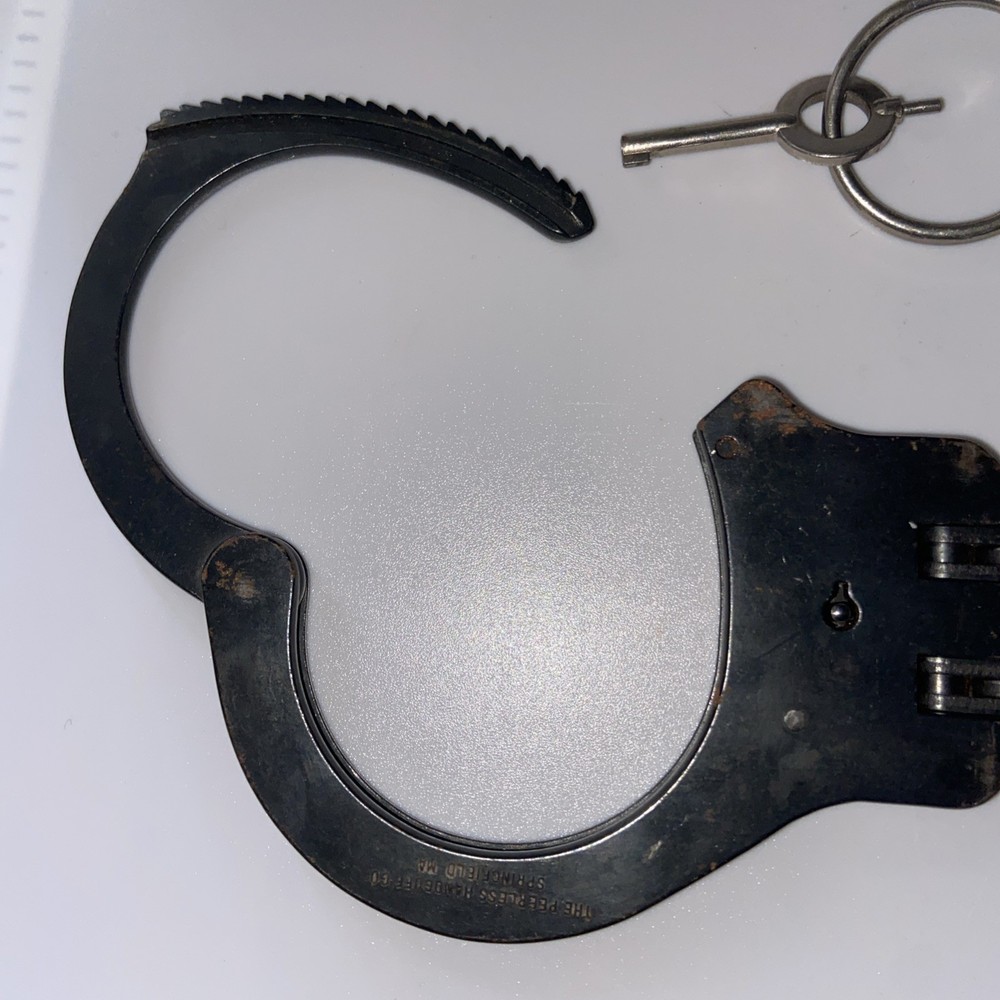 Vintage Peerless Hinge-Linked Handcuffs & Key On Monadnock Persuader
