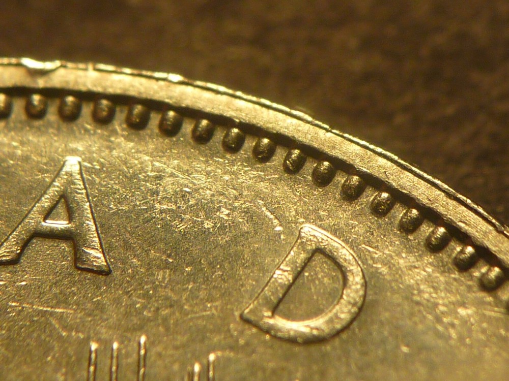 Error: Canada 1982 BU Voyageur nickel $1 with strike-through errors both sides