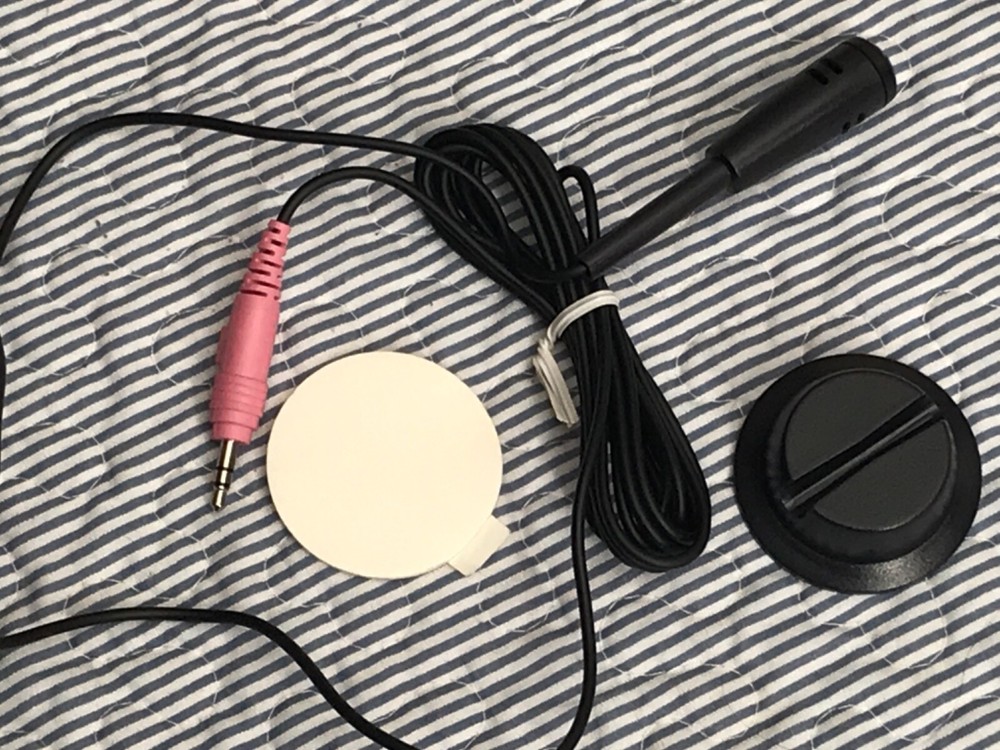 Mini microphone attachable to wall or desk
