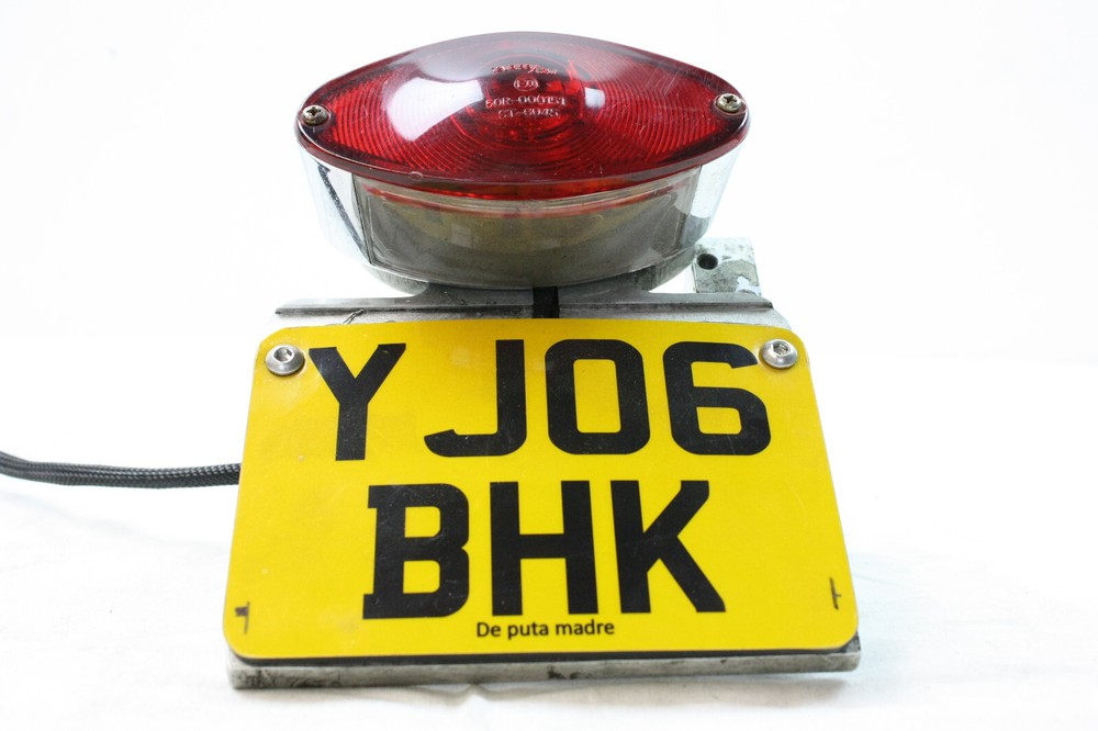 License plate holder side including lighting for Harley