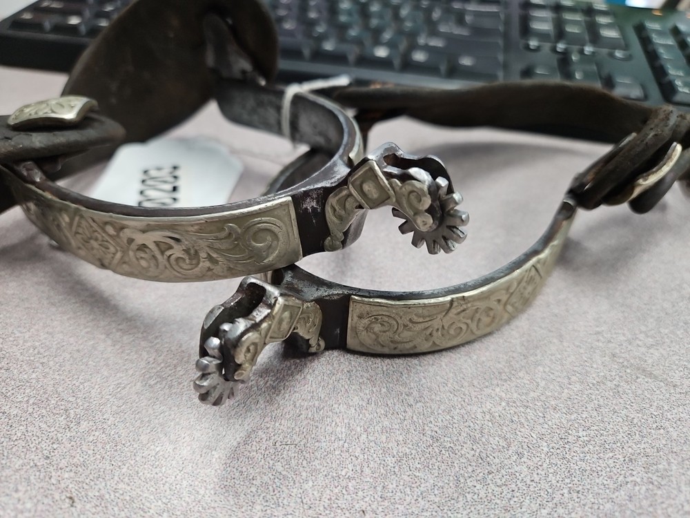 hand-forged spurs feature engraved silver inlay