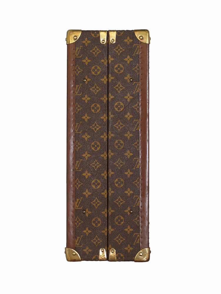 Louis Vuitton monogram suitcase trunk open by center, square handle.