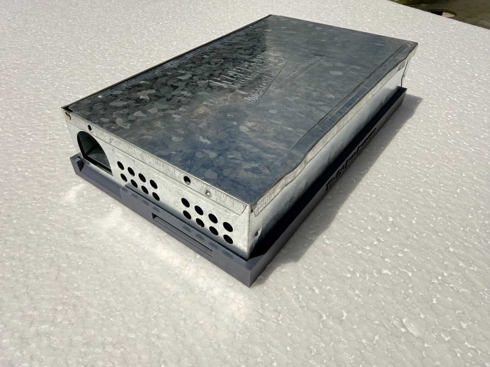 Tin cat mouse trap base protector.