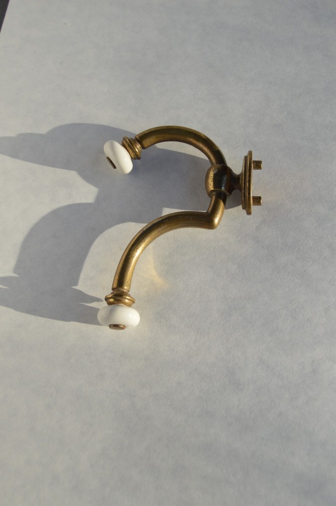 Solid brass with procelain hook that will hold securely is easy to mount .