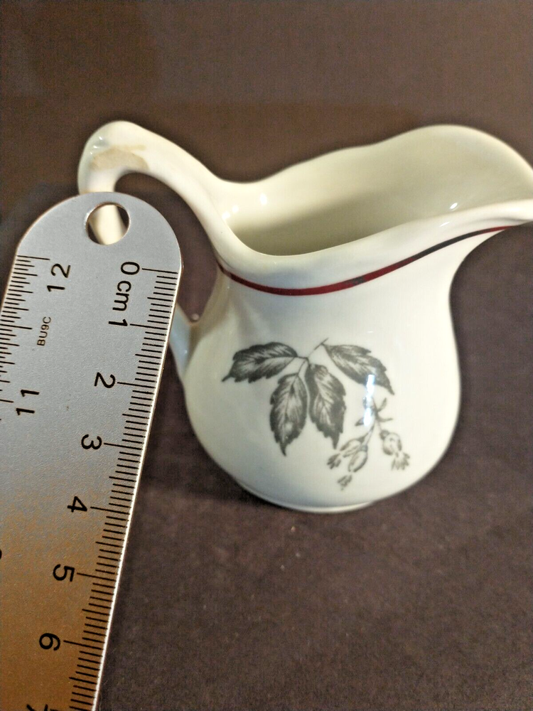 McNicol small creamer with glaze damage on handle