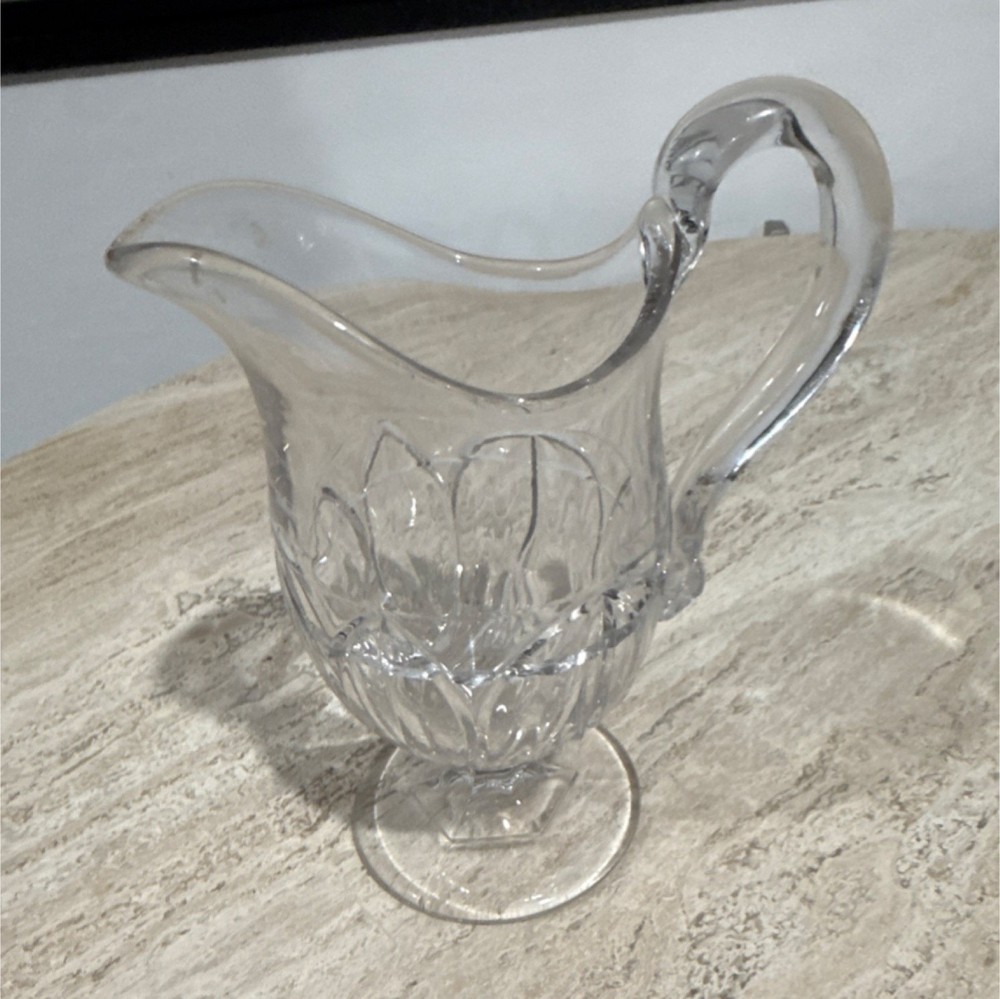 Clear pressed glass pitcher, round glossy finish with handle