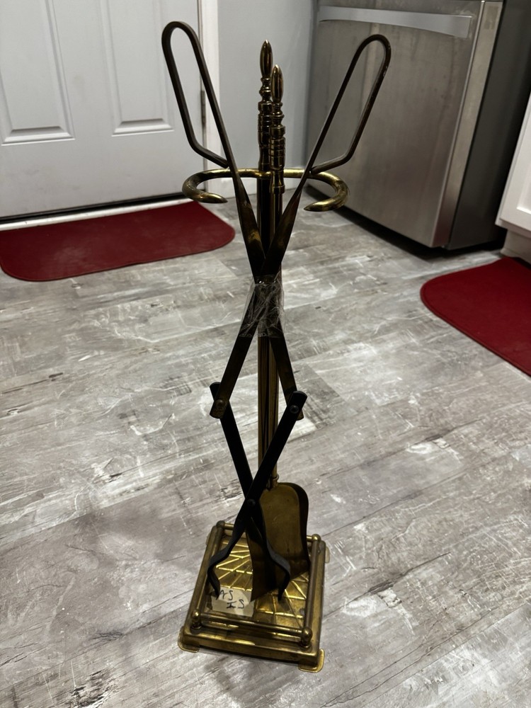 This item is a vintage brass fireplace tool set, typically featuring tools