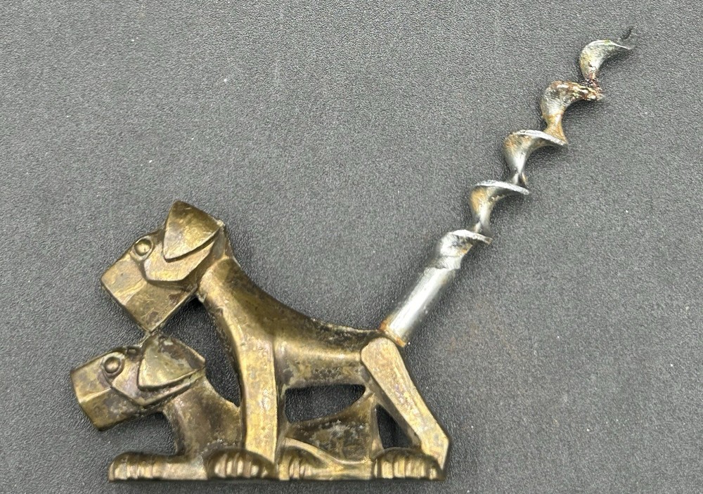 ART DECO CORKSCREW SOLID BRASS DOG. MARKED ENGLAND.