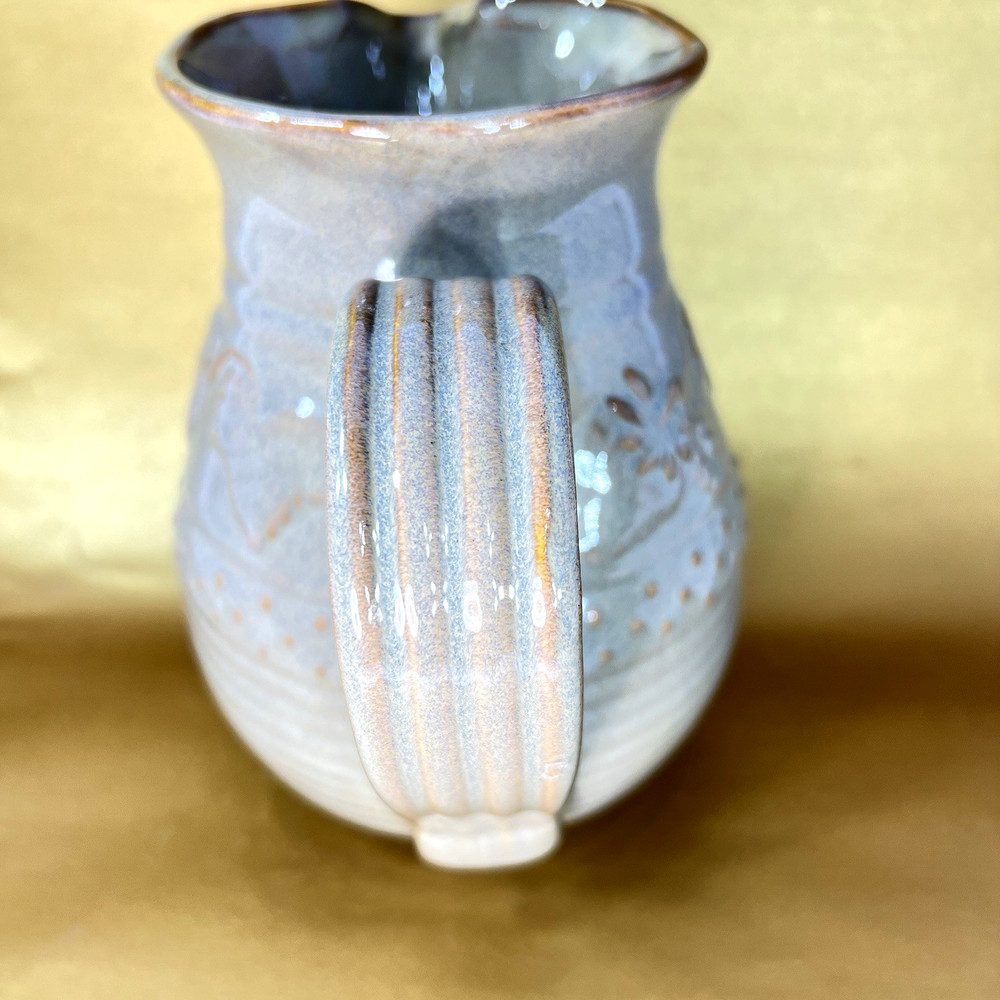 Unbranded Glazed Stoneware Pitcher embossed with fruit and glazed inside