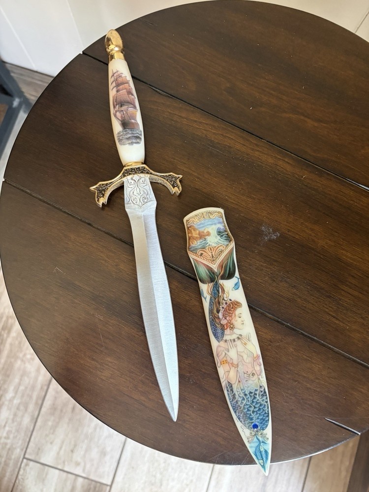 Dagger with pseudo-scrimshaw mermaids