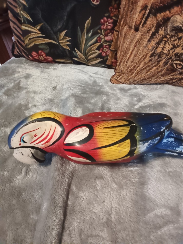 Worn painted ceramic parrot on metal perch,ceiling hanger.