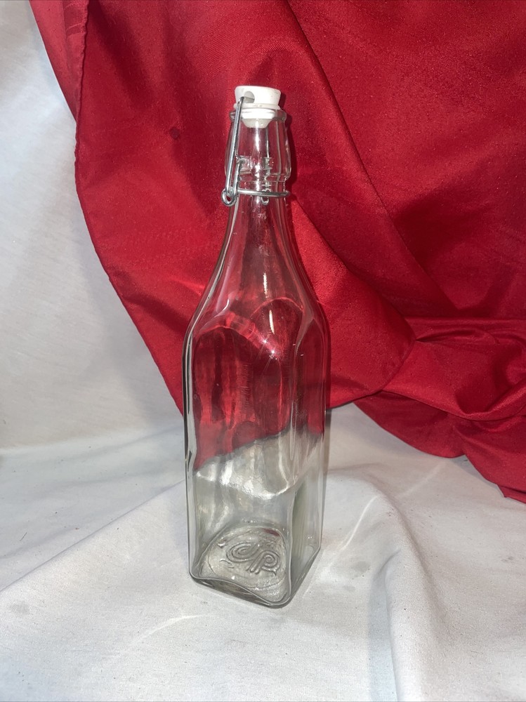 Clear bottle with latch lid- bottom has a b on it