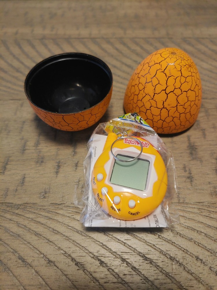 Orange Tamagotchi with dinosaur egg