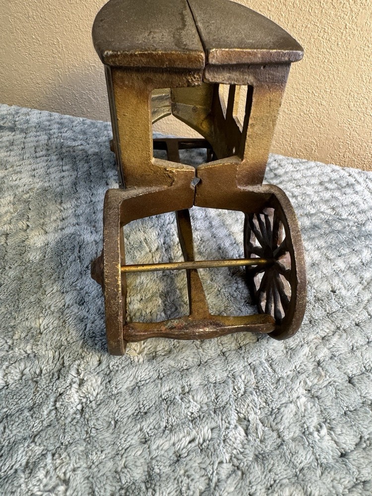 Antique cast iron pull toy carriage with decorative detailing and pull handle