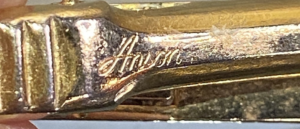 Two Tie Clips, One Marked Anson