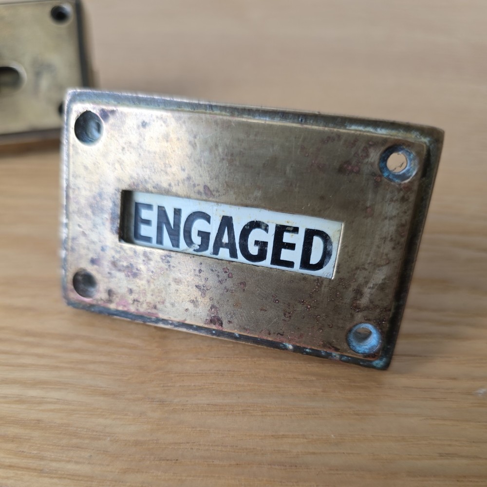 Antique brass vacant-engaged WC bathroom lock.
