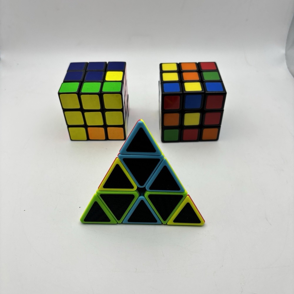 2 - Rubiks Cubes and  1 - Pyraminx Triangle Puzzle.  VG Condition.
