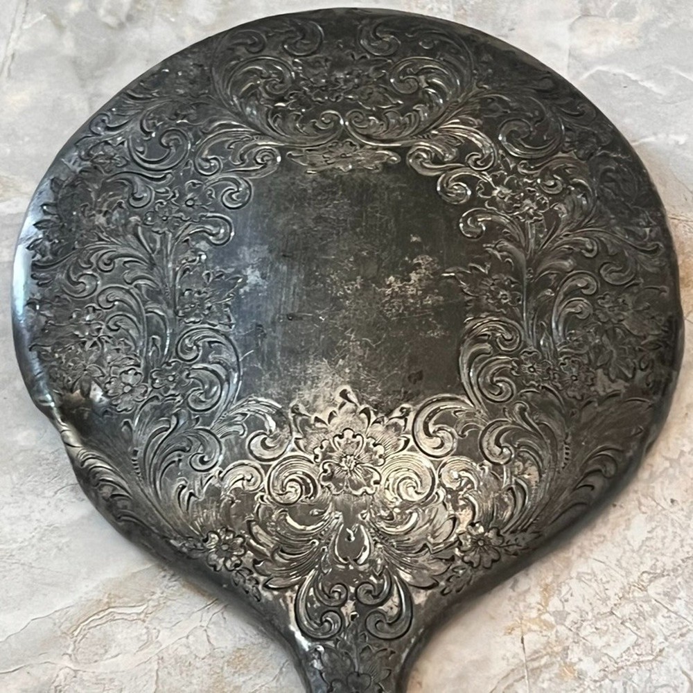 Silver Plated Hand Held Mirror with Intricate Raised Floral Scrollwork