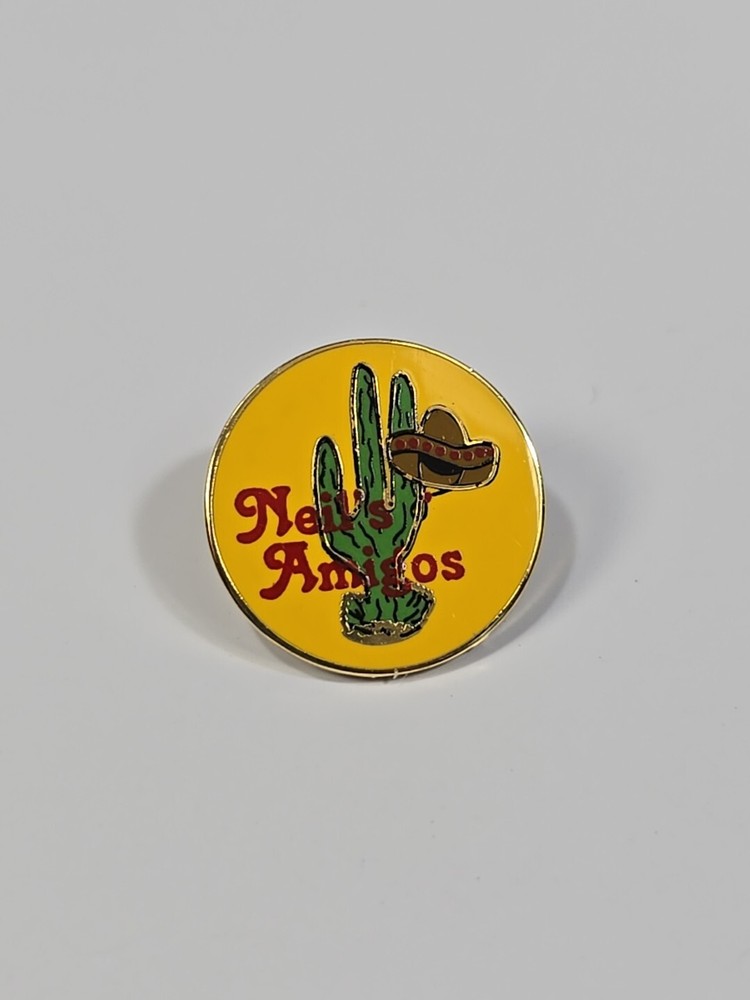Neil's Amigos Lapel Pin Cactus with Hat on Yellow Background