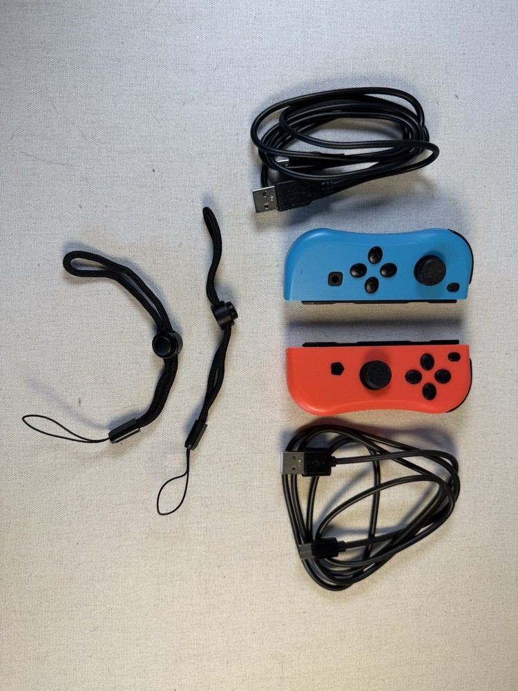 Nintendo Switch Joy-Con controllers accompanied by black USB-C charging cables.