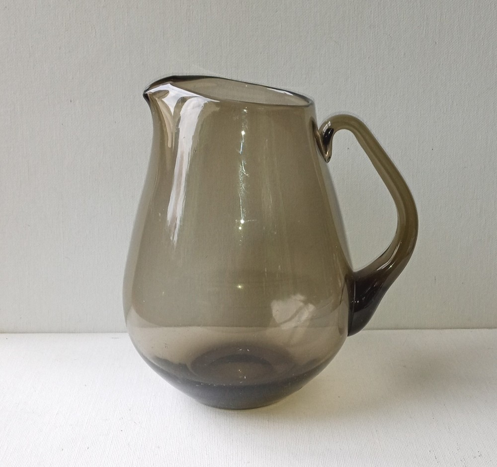 7 " Amber Colored Hand Blown Glass Pitcher. Holds 2 quarts. Has spout & handle.