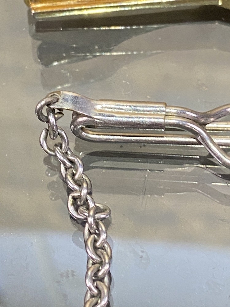 Two Tie Clips, One Marked Anson