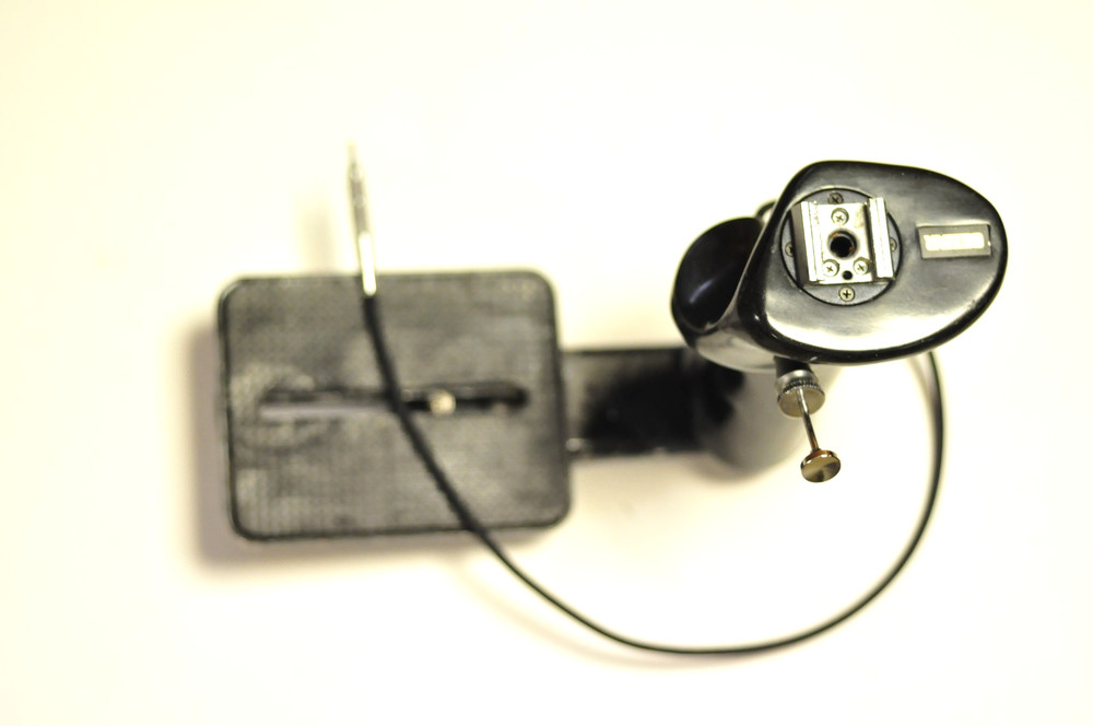 Suntar medium format flash / accessory / grip bracket with a cable release.