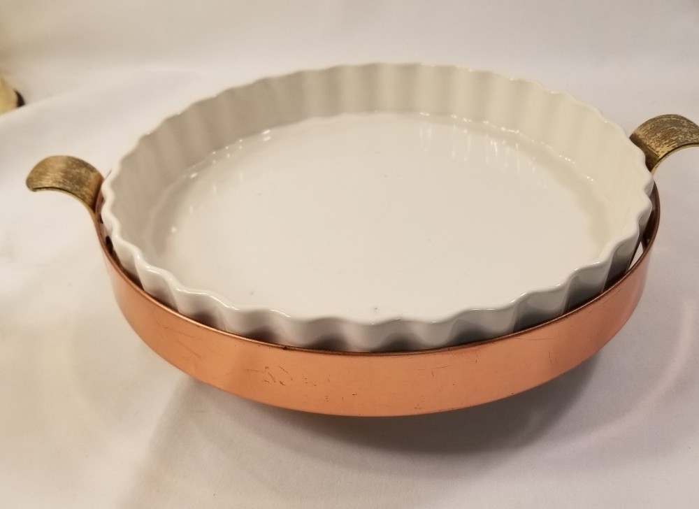 Copper and brass dish holder includes white ruffled dish
