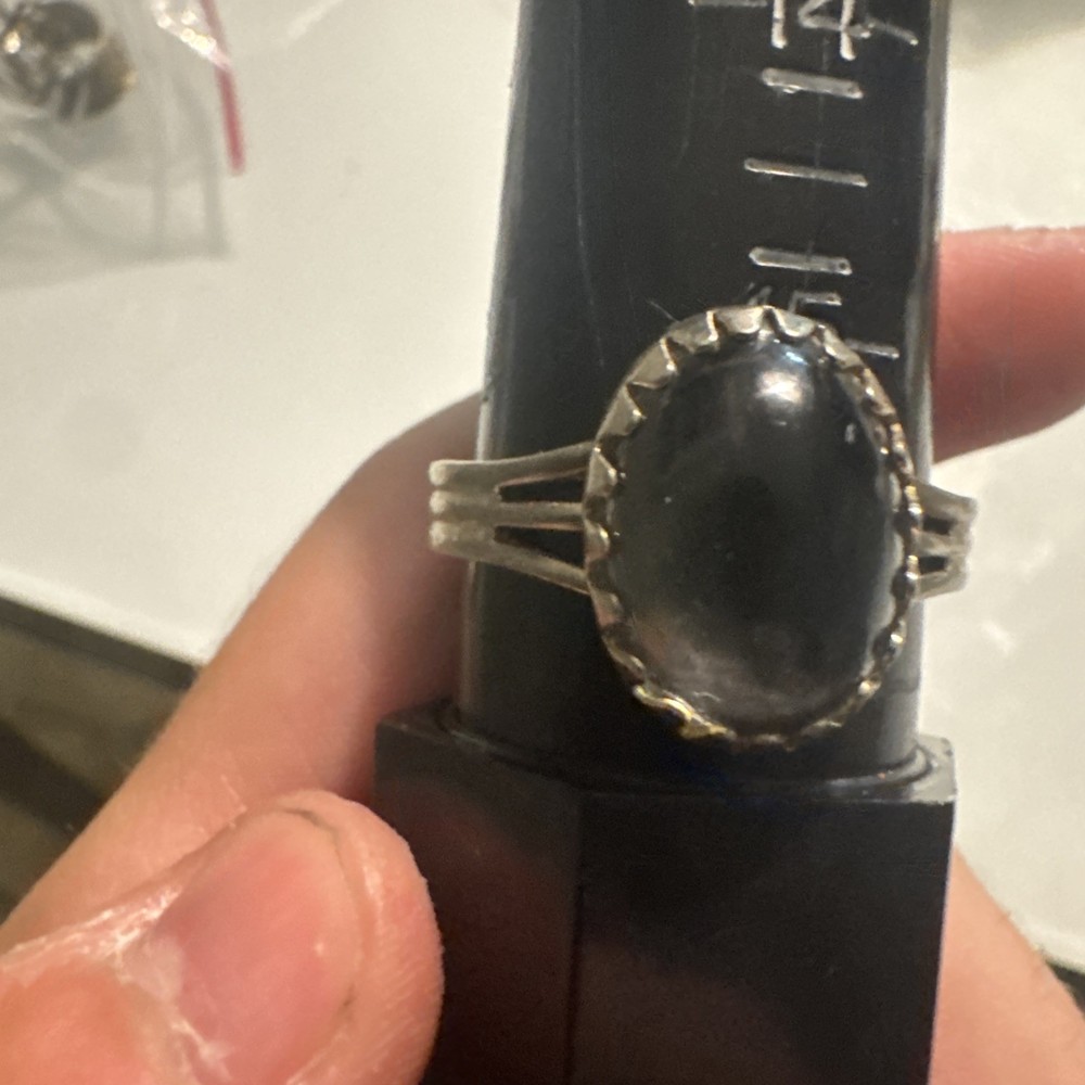 adjustable silver ring with colorless stone on front reflective