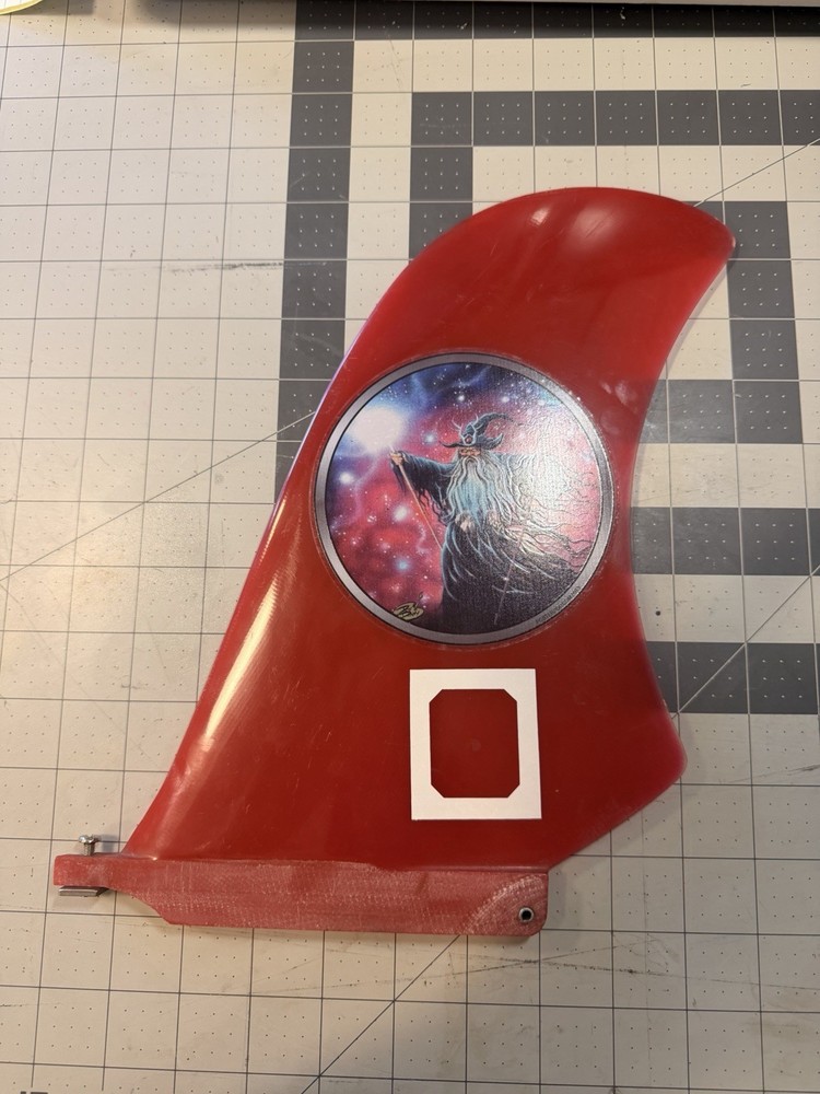 Red Surfboard Fin with Wizard Graphic