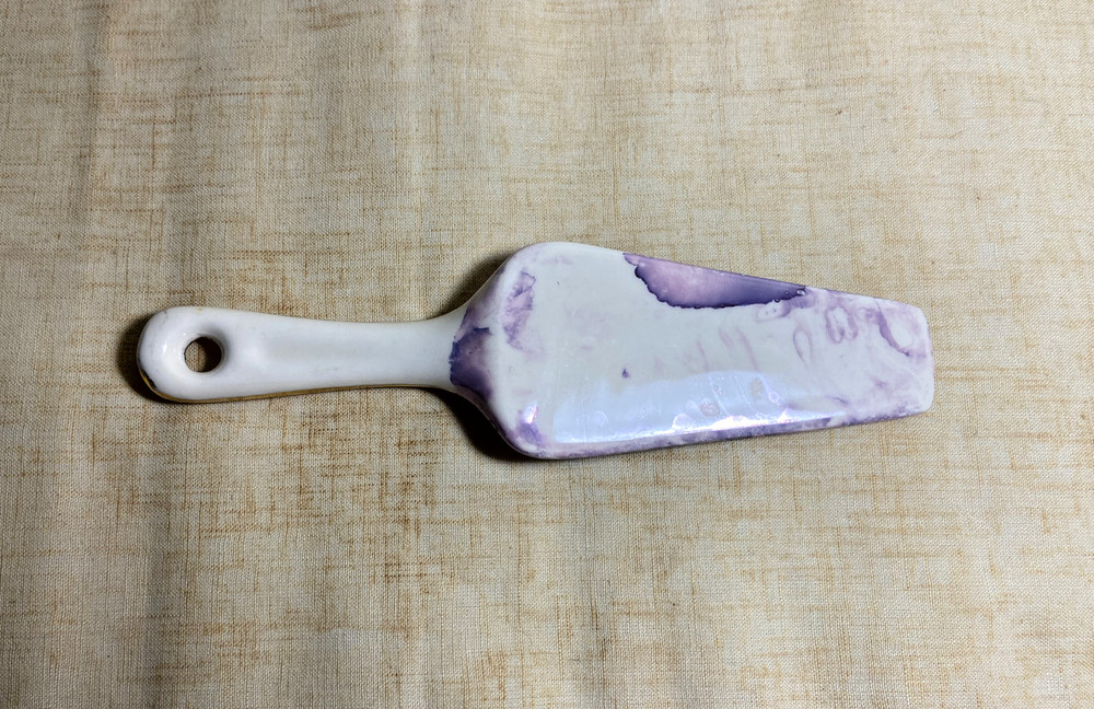 Contemporary cake server with purple marble blade and gold handle