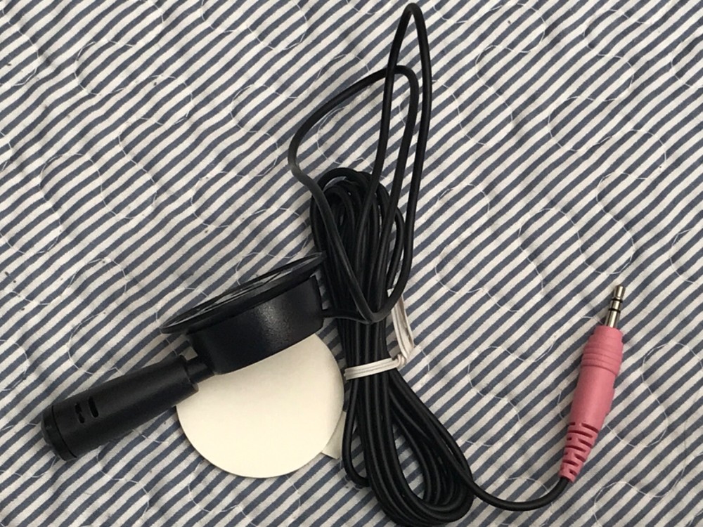 Mini microphone attachable to wall or desk