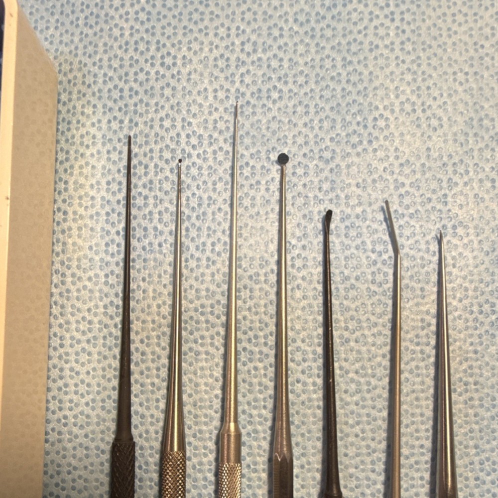 Seven piece otologic instrument pick set with case.
