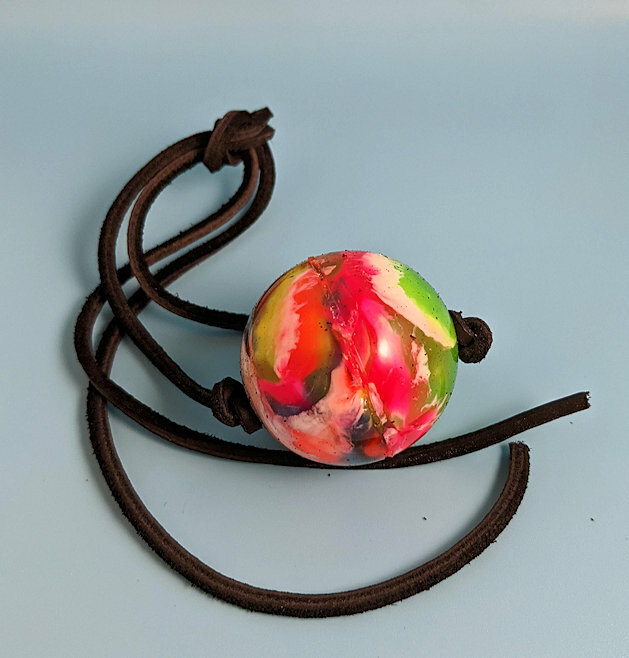 Colorful ball gag with leather strap.