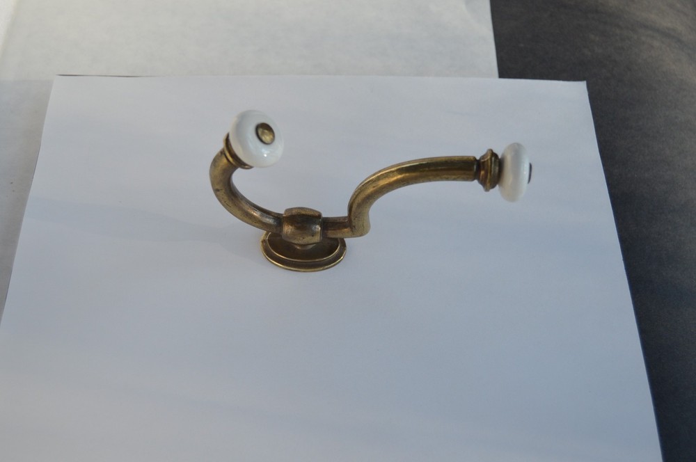 Solid brass with procelain hook that will hold securely is easy to mount .