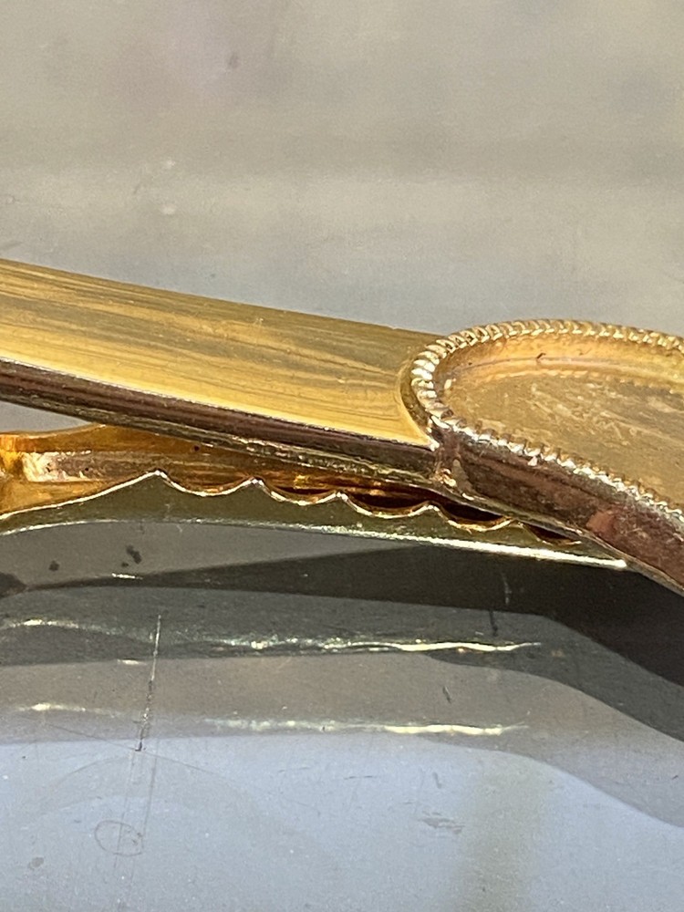 Two Tie Clips, One Marked Anson