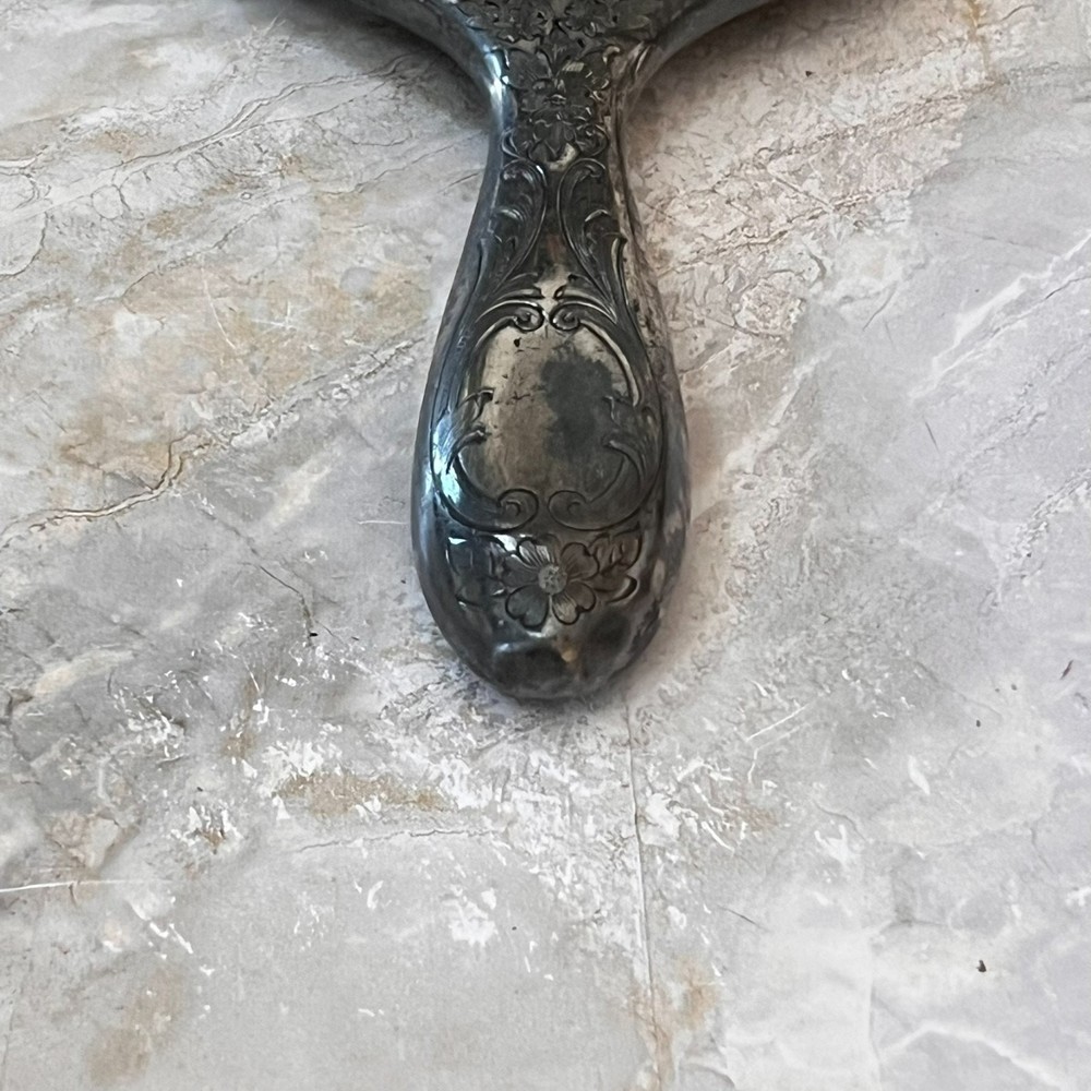 Silver Plated Hand Held Mirror with Intricate Raised Floral Scrollwork