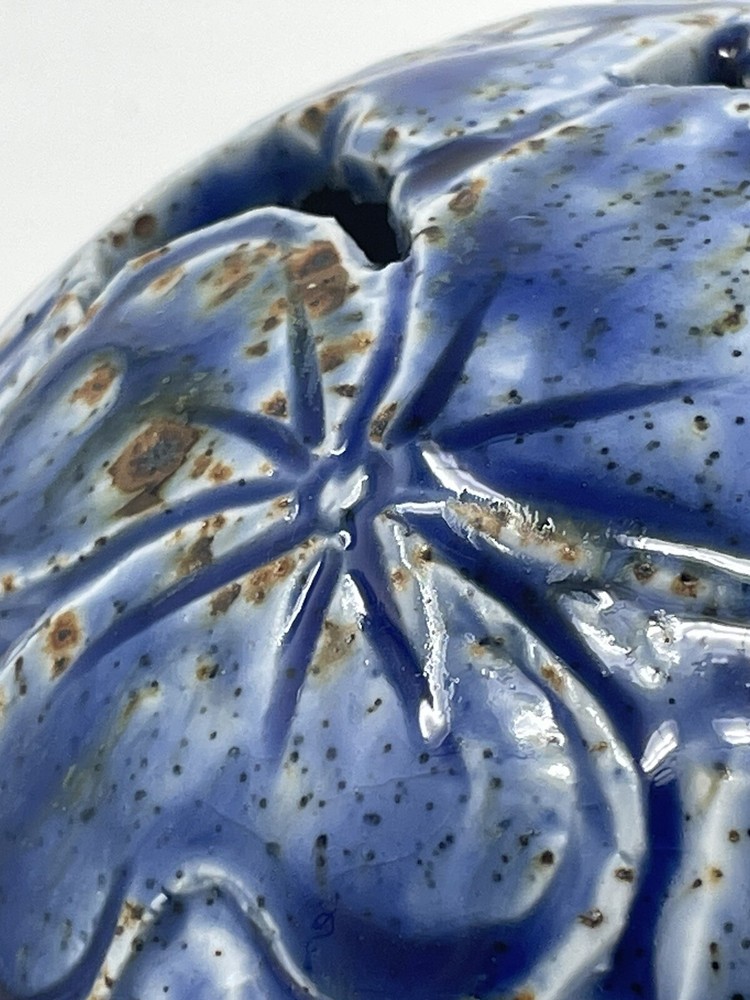 Pottery vase blue with brown specs .