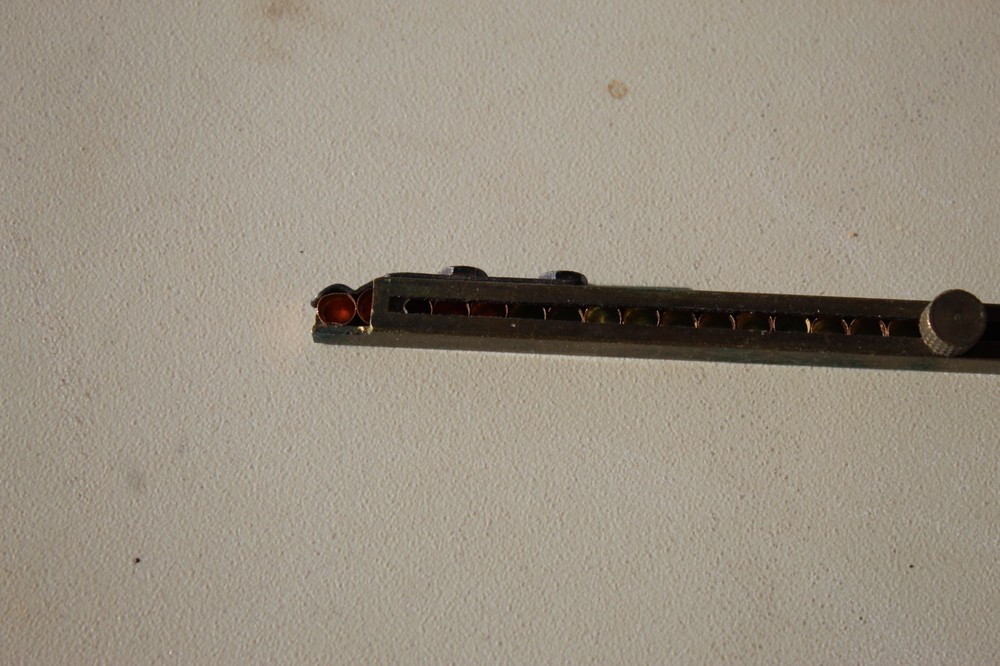 Brass straight-line percussion capper